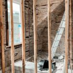 Woman standing in room with unfinished walls